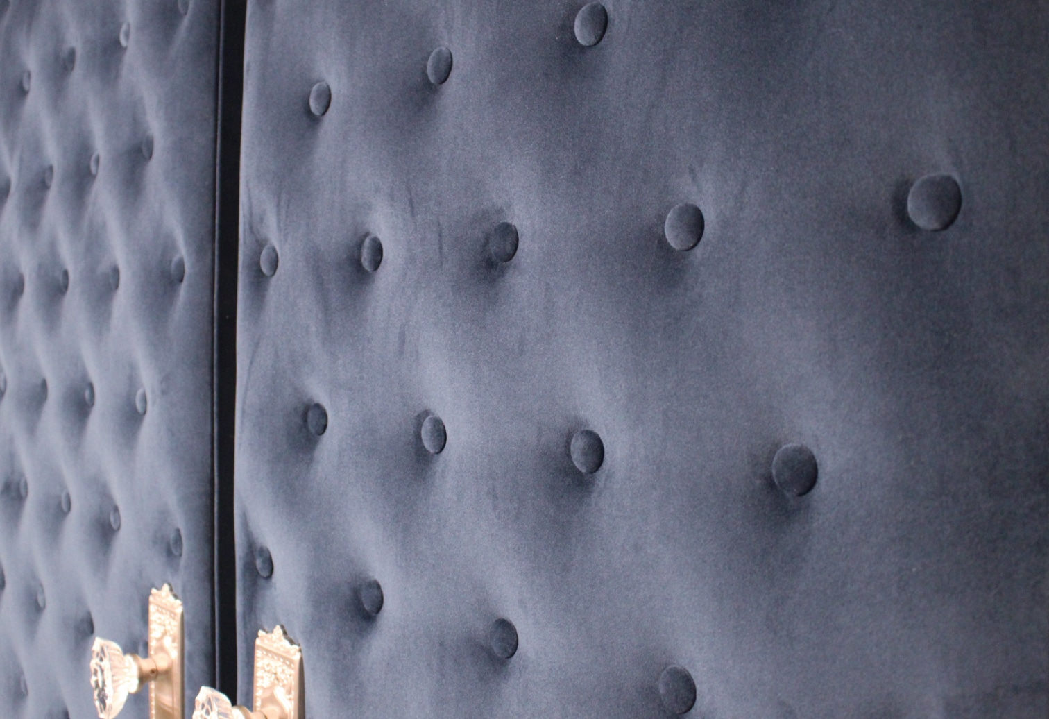 detail on custom made tufted home cinema room doors covered with velvet