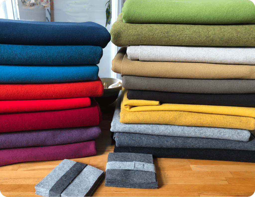 two stacks of several fabrics of different shades