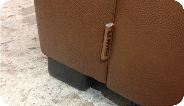 close-up of a LUWISS logo applied to vegan leather or vinyl