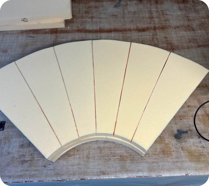 Assembling a set of 6 polyurethane foam pieces to form a rounded corner. These foam pieces will be used to pad the tubes for a bench seat.