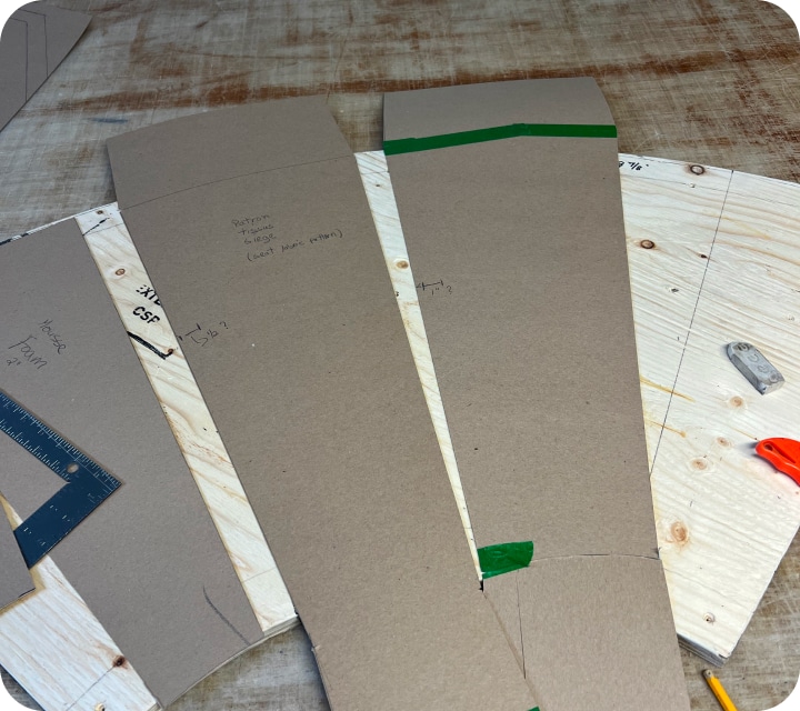 Close-up of a template for cutting fabric and polyurethane foam to form a set of flutes that will be installed on a bench seat.